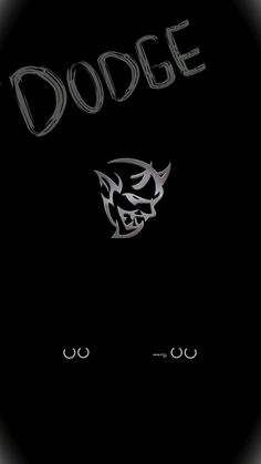 a black background with the word dodge written in silver letters and an image of a demon's head