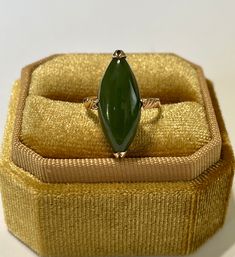 "Stylish 1960s Mid Century era 18k yellow gold genuine nephrite jade ring! This gorgeous ornate ring has a marquise shaped ring head, and contains a genuine green nephrite jade gemstone. A unique piece of fine vintage jewelry, featuring a genuine gemstone! ERA - Circa 1960s / Mid Century  METAL / MATERIAL - 18k yellow gold, genuine nephrite jade  MARKINGS / HISTORY - Inside band is marked \"18k\"  CONDITION - Good vintage condition. Yellow gold metal has been professionally polished & cleaned. Age appropriate patina & wear remains. Genuine nephrite jade secure. Amazing vintage genuine nephrite jade ring!  SIZE / MEASUREMENTS - Size: 4 1/2, Ring Head Height: 21.1 mm, Rise Of Ring Off Finger: 9 mm, Shank: 2.1 mm, Weight: 2.87 grams https://www.etsy.com/shop/LastCenturyJewels" Classic Green Marquise Rings, Classic Jade Rings For Formal Occasions, Vintage Marquise Emerald Ring For Formal Occasions, Mid-century Green Collectible Jewelry, Vintage Green Marquise Emerald Ring, Heirloom Gold Jade Ring, Heirloom Jade Ring In Gold, Heirloom Jade Rings In Yellow Gold, Heirloom Yellow Gold Jade Rings