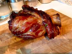 a large piece of meat sitting on top of a wooden cutting board