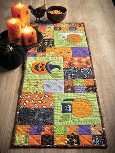 a halloween themed table runner with candles on it