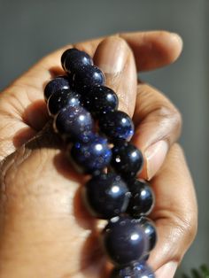 a person holding some beads in their hand