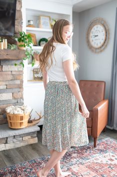 This is a skirt that falls below the knee and features pleats and a floral pattern. If you are wanting a skirt that evokes a sense of joy and movement as the seasons change from winter to spring this is it! This is a fun and trendy skirt with a floral pattern which might be the perfect addition to your wardrobe! Flowy Tiered Skirt With Floral Print, Spring Midi Pleated Skirt With Elastic Waistband, Spring Flowy Pleated Maxi Skirt, Flowy Midi Skirt For Garden Party, Chic Long Pleated Skirt With Floral Print, Casual Tiered Skirt For Garden Party, Floral Print Full Skirt Bottoms For Day Out, Chic Long Floral Print Pleated Skirt, Flowy Long Floral Print Pleated Skirt