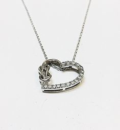 "Up for your consideration is a beautiful Sterling Silver necklace and Heart shaped pendant with CZs throughout! Marked \"Sterling\" on Necklace and \"Sterling\", \"CZs\" on Pendant back. Approx necklace length 18.0\" inches. Approx total weight 2.90 grams." Diamond Accented Heart Pendant Necklace For Mother's Day, Cubic Zirconia Heart Pendant Necklace, Mother's Day Diamond Heart Pendant Necklace, Mother's Day Heart Pendant Diamond Necklace, Sterling Silver Diamond Necklace With Heart Charm, Heart Pendant Necklaces For Mother's Day, Heart Pendant Necklaces For Mother's Day And Formal Occasions, Heart Pendant Necklace For Mother's Day Formal, Valentine's Day Heart Charm Diamond Pendant Necklace