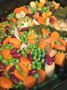 peas, carrots and broccoli are being cooked in the slow cooker