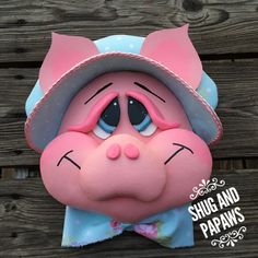 a close up of a pig mask on a wooden surface