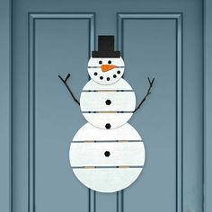 a snowman is hanging on the front door