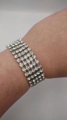 Weiss- 1960s Prong Set Rhinestone Bracelet- Vintage 5 Row Wide Rhinestone Bracelet- Glamorous Bracelet- Prom, Formal or Wedding Bling K#762 - Silver tone metal - Clear Prong Set Rhinestone Bracelet - Tongue clasp holds well and tight - Marked Weiss on the back of clasp - 5 Rows of Rhinestone wide - Width: 3/4 inches - Length: 7 inches - Good and clean condition Silver Rhinestone Costume Jewelry Bracelet, Silver Rhinestone Bracelets In Alloy, Silver Rhinestone Bangle, Vintage Rhinestone Bracelet For Evening, Designer Costume Jewelry, Prom Formal, Vintage Silver Clip-on Earrings With Rhinestones, Bethlehem Pa, Bling Wedding