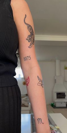 a woman's arm with tattoos on it