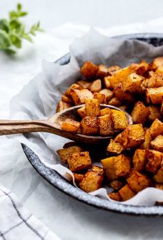 air fryer butternut squash cubes in a bowl with a spoon