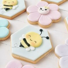 decorated cookies are arranged in the shape of hexagons and honeybees