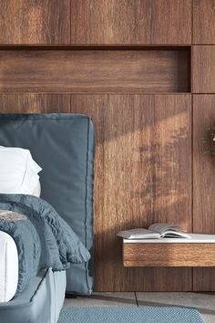 a bedroom with wood paneling and blue bedding