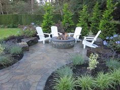 an outdoor fire pit surrounded by lawn chairs