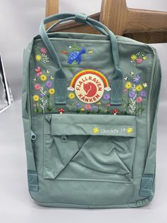 Welcome to my store and choose the perfect hand-embroidered fjallraven kanken backpack   Version & Size + Medium size: 38x27x13cm  + Big size: 42x32x13cm  - Product price includes: hand-embroidered fjallraven kanken backpack and design as shown in the picture - I can make fjallraven kanken backpack hand embroidery patterns according to your ideas - fjallraven kanken backpack will be hand embroidered with thread that won't fade when washed - fjallraven kanken backpack has a small front compartmen Embroidery On Backpack, Kanken Sling Bag, Backpack Embroidery, Flower Hand Embroidery, Stitch Backpack, School Bag Essentials, Embroidered Backpack, Embroidered Shoes, Embroidery On Clothes