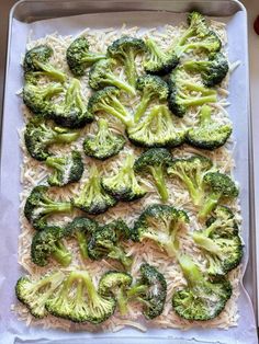 broccoli florets and rice on a baking sheet ready to go into the oven