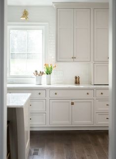 the kitchen is clean and ready for us to use it's white cabinetry