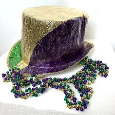 a mardi gras hat and beads on a table