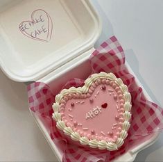 a heart shaped cake in a pink and white box