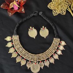 * This vintage coin necklace is an epitome of tradition, as the design of the set is inspired by the Afghani Kuchi ornaments. The rusty goldtoned set is embellished with dangling elements, adorned with multicolor glass stones and archaic motifs. You can pair this necklace with any traditional or trendy outfit and make a unique fashion statement. Note: The product is handmade, slight change might occur in the actual product. Temple Jewelry Necklaces With Matching Earrings For Festivals, Temple Jewelry Necklace With Matching Earrings For Festivals, Traditional Metal Necklaces For Celebrations, Ceremonial Temple Jewelry Necklace With Matching Earrings, Ceremonial Necklace Set With Earrings For Festivals, Vintage Necklace For Festivals And Celebrations, Traditional Antique Gold Necklaces For Celebration, Traditional Antique Gold Temple Necklace For Celebration, Ceremonial Festive Necklace With Matching Earrings