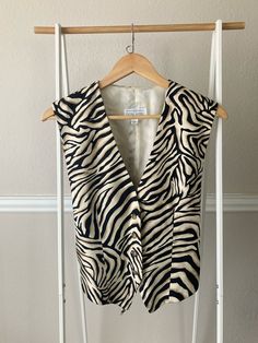 * beautiful tailored animal print vest * brown marbled buttons * Back it waist is adjustable  Measurements: Shoulder to shoulder 15.5" Armpit to armpit 18" Waist side to side 18" but adjustable Condition: Excellent  (ships clean and ready to wear) Visit the Vintage Tops section for more! https://www.etsy.com/shop/CosmicCountryVintage?ref=dashboard-header§ion_id=50205097 Calvin Klein Sleevless Animal Print, Tank Top Layering, Animal Print Vests, Top Layering, Brown Tiger, Linen Vest, Dashboard Header, Print Tank Top, Vest Outfits