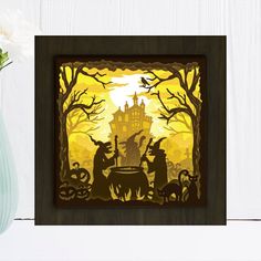 a paper cut out of a halloween scene with pumpkins and witches in the background