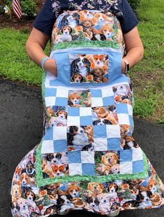 a woman is holding a quilted dog blanket