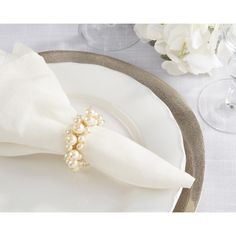 a white plate topped with a napkin covered in pearls