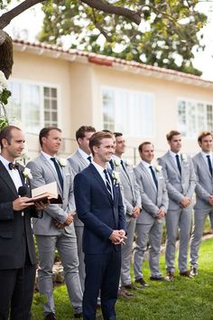 a group of men in suits standing next to each other