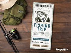 a fishing trip ticket sitting on top of a wooden table next to some fishing gear