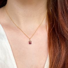 This beautifully simple necklace is lovingly handmade with a stunning AA+ grade Garnet gemstone and a 9ct Gold Chain. M A T E R I A L S: * Emerald Cut Garnet * Grade - AA+ * Origin - Mozambique * 9ct Solid Gold Chain S I Z E: *  Pendant - Approximately 8x6mm *  Chain Thickness - Approximately 1.1mm  All of our jewellery is carefully handmade using good quality materials and handpicked gemstones, with the aim to produce quality pieces that you can love & wear for years to come.  G A R N E T: * January Birthstone * Talisman for Aries, Virgo, Leo * Base Chakra, Heart Chakra Garnet cleanses and re-energises the chakras.  It revitalises, purifies and balances energy, bringing serenity or passion as appropriate.  Inspires love and devotion. Your necklace will arrive in a white jewellery box read Classic Necklace With Rectangular Stone As Gift, Minimalist Necklace With Rectangular Stone As Gift, Minimalist Necklace With Rectangular Stone For Gift, Minimalist Rectangular Stone Necklace For Gift, Rectangular Birthstone Jewelry Gift, Dainty Rectangular Birthstone Necklace, Emerald Cut 14k Gold Necklace For Gift, 14k Gold Gemstone Rectangular Pendant Necklace, 14k Gold Necklace With Gemstone In Rectangular Pendant