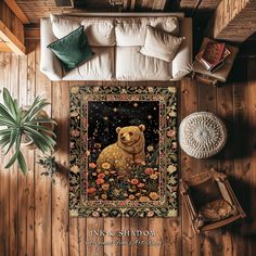 a tapestry with a brown bear on it in a living room next to a couch