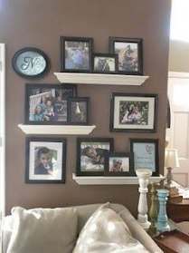 a living room filled with lots of pictures on the wall and furniture in front of it