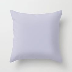 a white pillow on a white wall with a light purple color in the middle and bottom