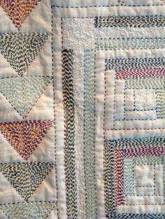 a close up view of a quilted wall hanging