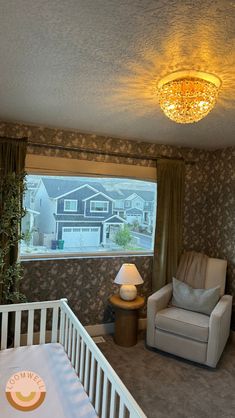 a baby's room with a crib, rocking chair and lamp in it