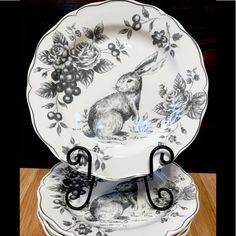 three black and white plates with rabbits on them