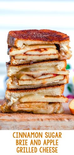 a stack of pancakes sitting on top of a wooden cutting board next to sliced apples