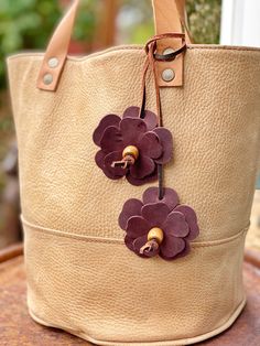 a tan bag with purple flowers on it