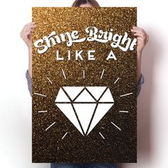 a woman holding up a poster with the words shine bright like a diamond on it