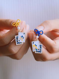 ⭐️ Introducing our kawaii earrings that are added to the new collection ENAMEL KAWAII Link: https://www.etsy.com/shop/EasternDragonShop?ref=shop-header-name&listing_id=1529609045&from_page=listing&section_id=48840336 ⭐️ The dangles showcase intricately designed cute elements, adding a unique touch to your look. The design features a rabbit shape hoop with a string of poker cards in the middle.  ⭐️ Crafted with hypoallergenic materials, these earrings offer a comfortable and safe wearing experien Cute Alice In Wonderland, Rabbit Shape, Kawaii Earrings, Poker Cards, Cheshire Cat, Daily Outfits, Wedding Shop, Alice In Wonderland, Poker