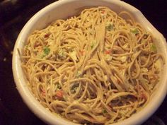 a white bowl filled with noodles and vegetables