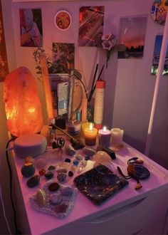 a table topped with lots of different types of rocks and candles on top of it