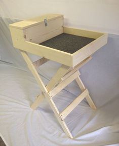 a small wooden table with a drawer on the top and two legs attached to it