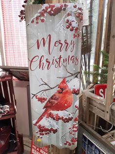 a merry christmas sign with a cardinal on it