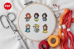 the cross stitch pattern is being displayed with scissors and thread