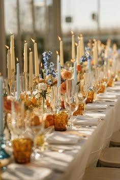 a long table with candles and flowers on it