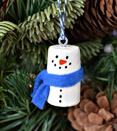 a snowman ornament hanging from a christmas tree