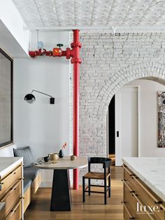 a white brick wall and ceiling in a kitchen