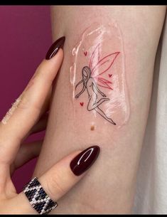 a woman's arm with a tattoo on it that has an image of a fairy