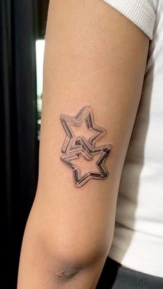 a woman's arm with a tattoo on it that is shaped like a star