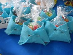 several bags filled with candy sitting on top of a blue table